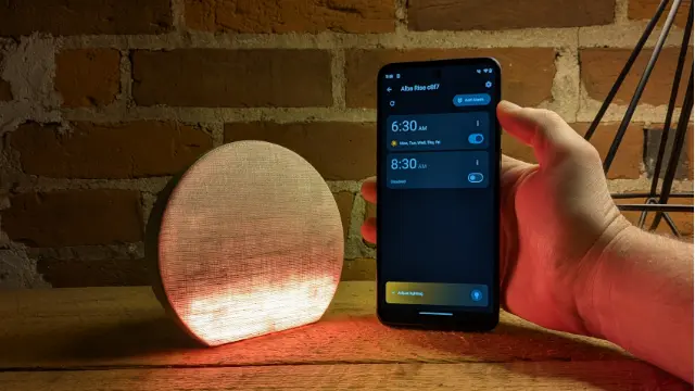 Alba Rise alarm clock glowing in a room